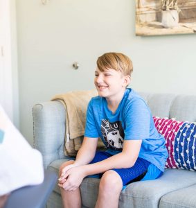 A young boy interacting with a therapist in an office