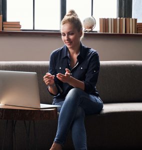 A woman having a teleconference using her laptop