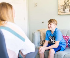 A young boy interacting with a therapist in an office