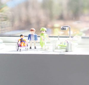 A series of children's toys sitting on a window sill