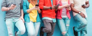 A group of teens on their phones