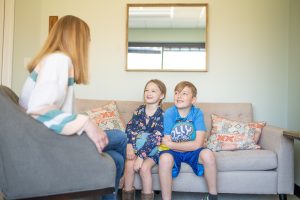 Siblings in a family therapy session with female therapist